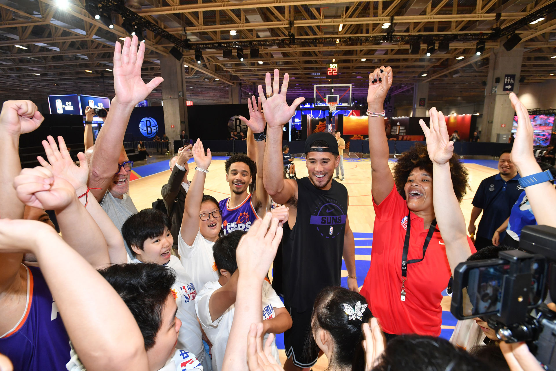 NBA Social Impact hero - player celebrating with community youth on a basketball court
